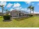 Well-maintained backyard with screened-in pool and manicured landscaping at 1082 Dartford Dr, Tarpon Springs, FL 34688