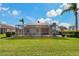 Manicured backyard with a screened-in pool and well-kept green lawn at 1082 Dartford Dr, Tarpon Springs, FL 34688