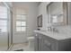 Bathroom featuring a gray vanity with marble countertop, and glass shower at 1082 Dartford Dr, Tarpon Springs, FL 34688