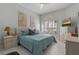 Bedroom featuring serene decor, a ceiling fan, and large windows that provide natural light at 1082 Dartford Dr, Tarpon Springs, FL 34688