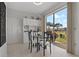 Bright breakfast nook features built-in cabinets, tile flooring and large sliding glass doors to enjoy Florida sunshine at 1082 Dartford Dr, Tarpon Springs, FL 34688