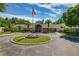 Exterior of an elegant clubhouse featuring a circular driveway and mature landscaping at 1082 Dartford Dr, Tarpon Springs, FL 34688