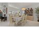 Light and bright dining room with neutral tones, tile flooring and view of the kitchen through breakfast bar at 1082 Dartford Dr, Tarpon Springs, FL 34688