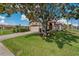 Well-maintained home featuring a manicured lawn, lush landscaping, and an attached two-car garage at 1082 Dartford Dr, Tarpon Springs, FL 34688
