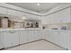 Spacious kitchen with all-white appliances, countertops, and cabinetry at 1082 Dartford Dr, Tarpon Springs, FL 34688