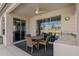 Outdoor patio with a ceiling fan, dining table, and an outdoor bar at 1082 Dartford Dr, Tarpon Springs, FL 34688