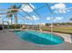 Relaxing screened-in pool area offering a pristine pool and serene views of the surrounding landscape at 1082 Dartford Dr, Tarpon Springs, FL 34688