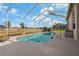 Screened-in pool with clear blue water overlooking a beautiful green lawn at 1082 Dartford Dr, Tarpon Springs, FL 34688