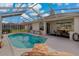 Inviting screened-in pool with outdoor seating and lounge furniture at 1082 Dartford Dr, Tarpon Springs, FL 34688