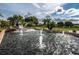 Stunning water feature with multiple fountains surrounded by lush landscaping at 1082 Dartford Dr, Tarpon Springs, FL 34688