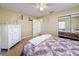 Bright bedroom featuring a white dresser, carpeted floors, and a mirrored closet at 11411 Pike Ct # 5, New Port Richey, FL 34654