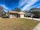 Brick ranch home with two-car garage and well-maintained lawn at 11729 White Ash Dr, New Port Richey, FL 34654