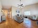 Bright living room with hardwood floors, comfy seating, and a ceiling fan at 11729 White Ash Dr, New Port Richey, FL 34654