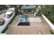 An aerial view of a home showcasing a screened-in pool, solar panel, and a spacious backyard with a storage shed at 11731 Linden Dr, Spring Hill, FL 34608