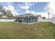Backyard features a large screened-in porch and green lawn at 11731 Linden Dr, Spring Hill, FL 34608