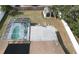 Aerial view of a home's backyard featuring a screened-in pool and a storage shed at 11731 Linden Dr, Spring Hill, FL 34608