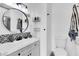 Modern bathroom featuring a new sink, circular mirror, and black and white accent tiles at 11731 Linden Dr, Spring Hill, FL 34608