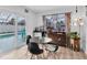 Dining area overlooking the pool featuring a modern table with seating for four at 11731 Linden Dr, Spring Hill, FL 34608