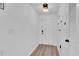 Bright entryway featuring hardwood floors, white door, and closet, with a modern light fixture at 11731 Linden Dr, Spring Hill, FL 34608