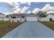 Charming single-story home featuring a well-manicured lawn, white picket fence, and attached two-car garage at 11731 Linden Dr, Spring Hill, FL 34608