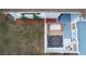 Aerial view of a home's front yard featuring a cozy porch with swing and charming landscaping at 11731 Linden Dr, Spring Hill, FL 34608