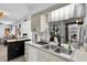 Bright kitchen featuring a stainless steel sink and a view of the home's open floor plan at 11731 Linden Dr, Spring Hill, FL 34608