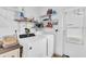 Bright laundry room with washer, dryer, shelves and exterior door at 11731 Linden Dr, Spring Hill, FL 34608