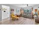 Bright living room boasts a large window, grey sofa, a yellow chair, and modern decor at 11731 Linden Dr, Spring Hill, FL 34608