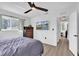 Bright bedroom featuring a ceiling fan, wood flooring, a window, and a chest of drawers at 11731 Linden Dr, Spring Hill, FL 34608