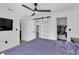 Spacious bedroom with updated flooring, ceiling fan, closet, and access to the bathroom at 11731 Linden Dr, Spring Hill, FL 34608