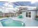 Screened-in pool area featuring a sparkling pool, patio furniture and sunny skies at 11731 Linden Dr, Spring Hill, FL 34608