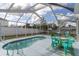 Screened-in pool area featuring a sparkling pool, patio furniture and sunny skies at 11731 Linden Dr, Spring Hill, FL 34608