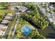 Aerial view of community with tennis courts, pool, and clubhouse at 11830 Wax Myrtle Ct, New Port Richey, FL 34654