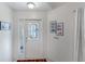 Bright entryway with a glass door and framed pictures at 11830 Wax Myrtle Ct, New Port Richey, FL 34654