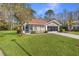 Single-story house with a large green lawn at 11830 Wax Myrtle Ct, New Port Richey, FL 34654