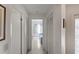 Clean hallway with tile floor and linen closets at 11830 Wax Myrtle Ct, New Port Richey, FL 34654