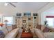 Relaxing living room with two sofas and built-in bookcases at 11830 Wax Myrtle Ct, New Port Richey, FL 34654