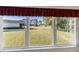Scenic view of grassy backyard, trees, and golf course at 11830 Wax Myrtle Ct, New Port Richey, FL 34654