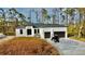 Modern, single-story home with a two-car garage and golf cart at 12102 Chapman Ave, Port Charlotte, FL 33953