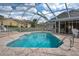 Relaxing pool area with screened enclosure at 13429 Lawrence St, Spring Hill, FL 34609