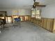 A living room with significant water damage and debris, needing complete renovation at 13737 Michelle Ave, Hudson, FL 34667