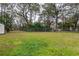 Spacious backyard with a fenced perimeter and mature trees at 1378 Haulover Ave, Spring Hill, FL 34608