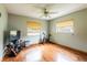 Bright bedroom with hardwood floors, ceiling fan, and large windows at 1378 Haulover Ave, Spring Hill, FL 34608