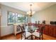 Charming dining room with glass table and view of backyard at 1378 Haulover Ave, Spring Hill, FL 34608