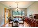 Bright dining area with glass table and French doors to backyard at 1378 Haulover Ave, Spring Hill, FL 34608