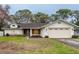 One-story home with attached garage, landscaped lawn, and neutral exterior at 1378 Haulover Ave, Spring Hill, FL 34608