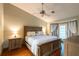 Bright main bedroom with hardwood floors, ceiling fan, and large windows at 1378 Haulover Ave, Spring Hill, FL 34608
