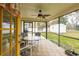 Relaxing screened porch with patio furniture and view of the backyard at 1378 Haulover Ave, Spring Hill, FL 34608