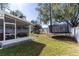 Large backyard with playset, trampoline, and screened porch at 14004 Cascade Ln, Tampa, FL 33618