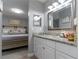 Bathroom with granite countertop, white cabinets, and stylish mirror at 14004 Cascade Ln, Tampa, FL 33618